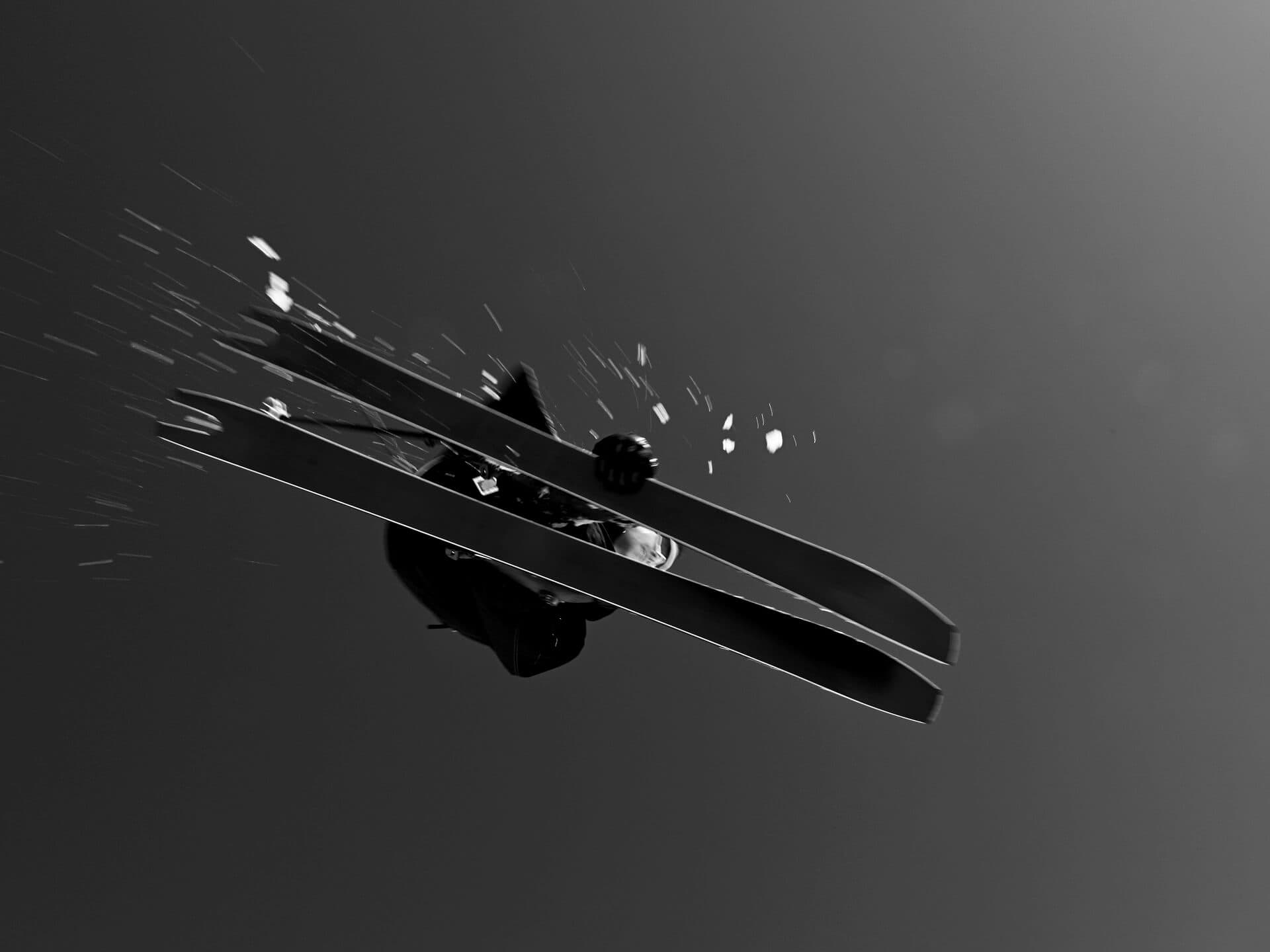Skier dropping mid-air over slope in black and white