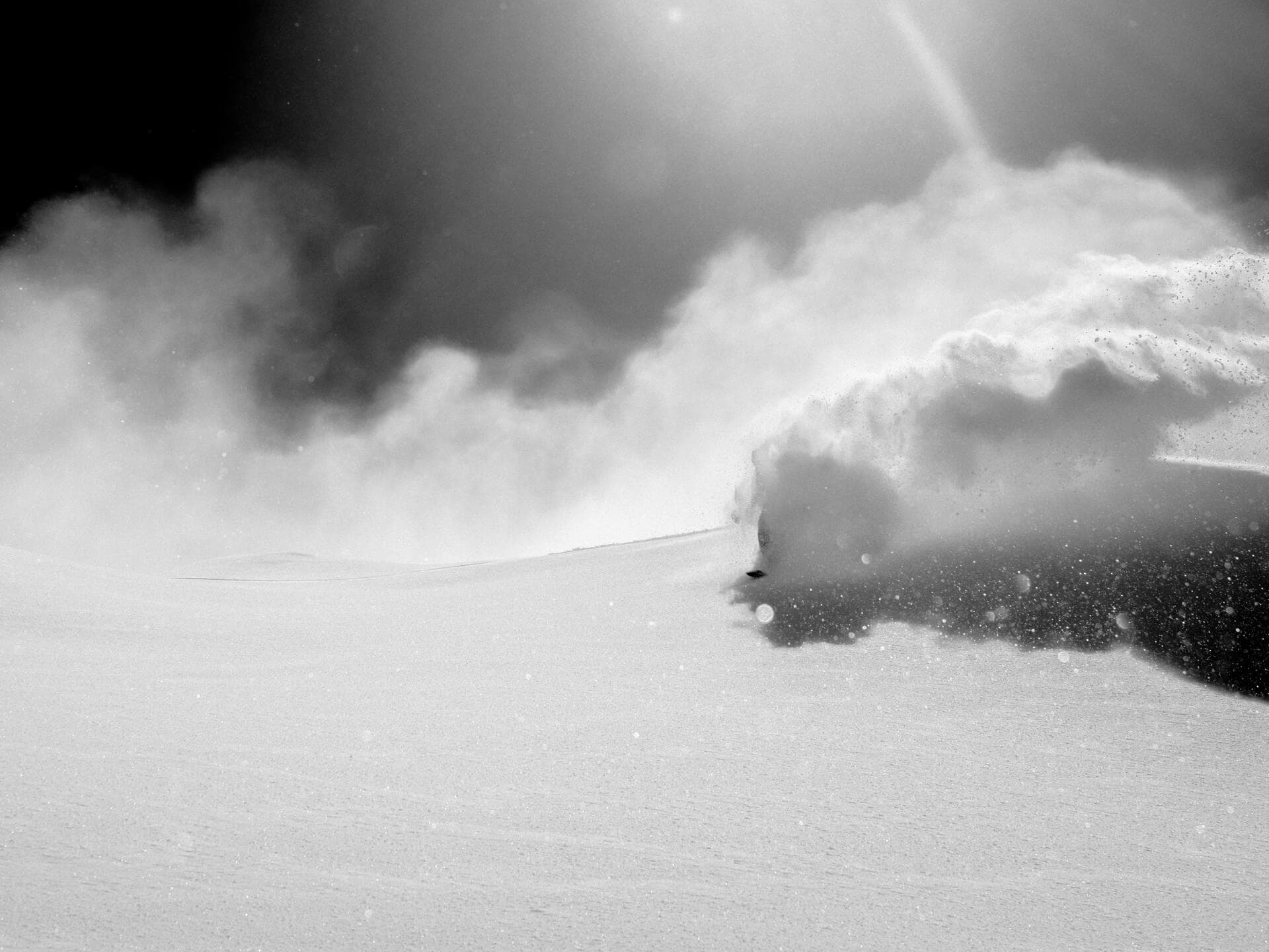 Laurent De Martin in powder riding simply. skis called Celebration 187 through open powder field with snow cloud
