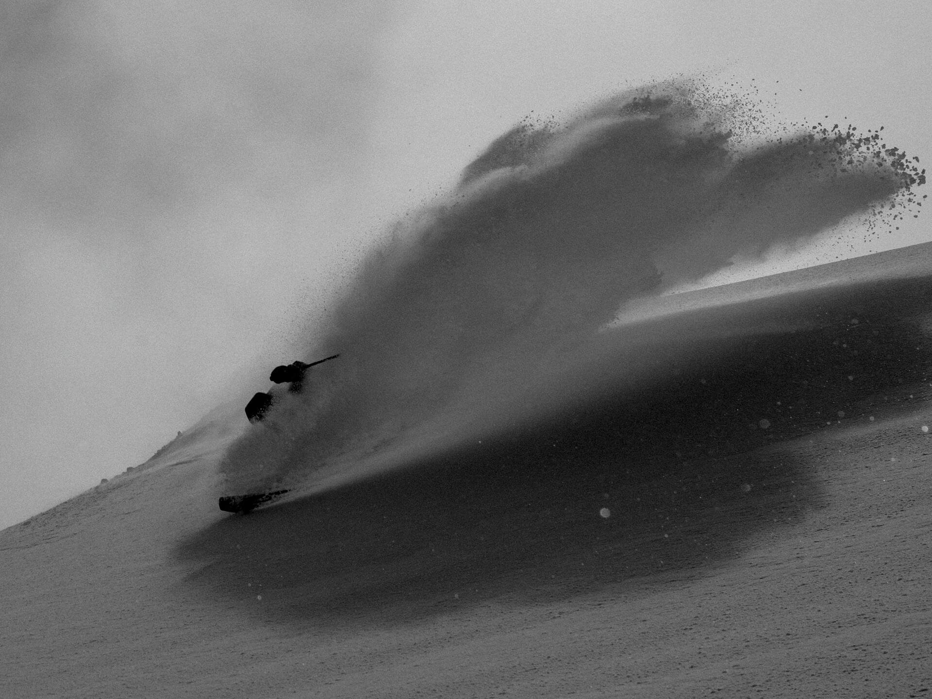 Laurent De Martin exploding through powder with snow spray